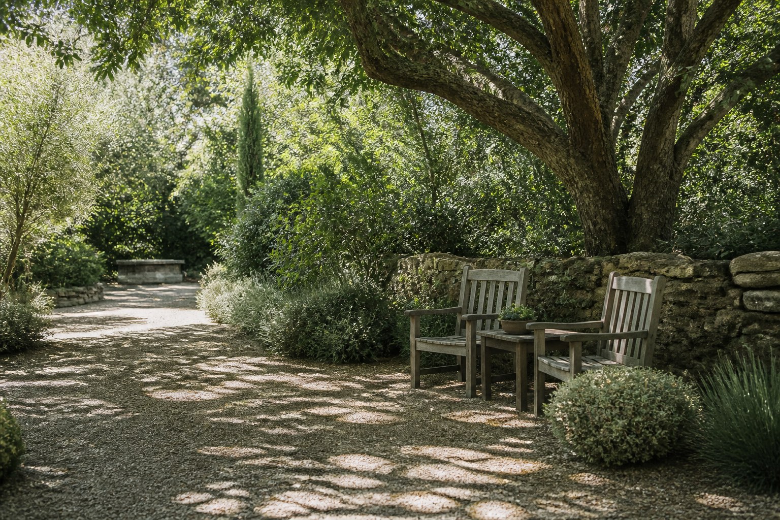 A quiet shaded corner of the retreat grounds with seating under the trees
