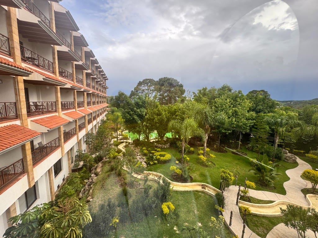 Guest rooms with terracotta balconies looking over the gardens and winding paths